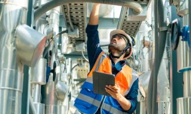 Safety officer conducting workplace audit inspection with checklist