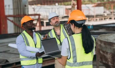 Construction supervisor leading team while wearing PPE on job site